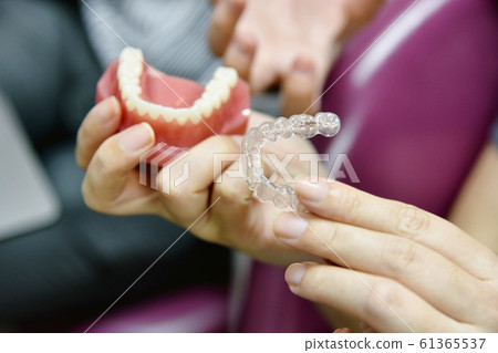 Inivisalign braces or aligner. Dentist advice how invisible orthodontics. 61365537