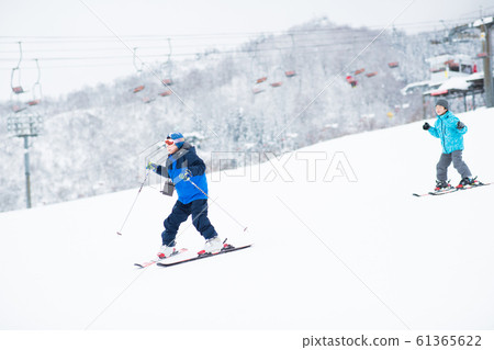 Kids enjoying skiing Kids enjoying skiing 61365622