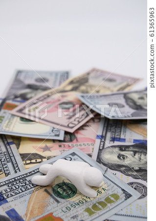 Depressed person riding on a dollar bill Vertical position White background Depressed person riding on a dollar bill Vertical position White background 61365963