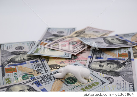 A person sitting on a dollar bill and falling down. Horizontal position White background 61365964