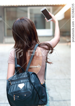 young and cute girl do self portrait with cell young and cute girl do self portrait with cell 61368235