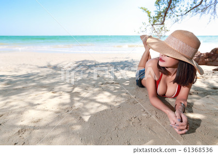 portrait of sexy asian young girl in red bikini and hat, looking away portrait of sexy asian young girl in red bikini and hat, looking away 61368536
