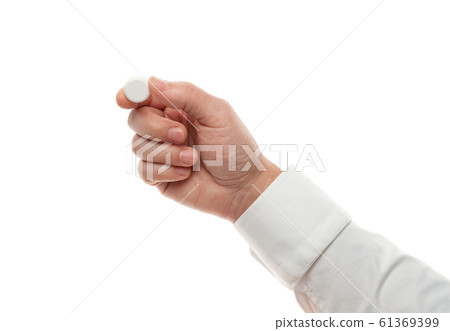 Man hand with one big white pill isolated on white 61369399