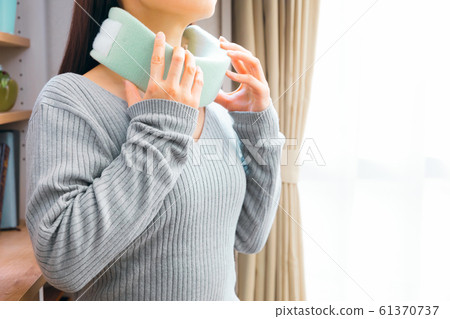 A woman wearing a collar and corset on her neck A woman wearing a collar and corset on her neck 61370737