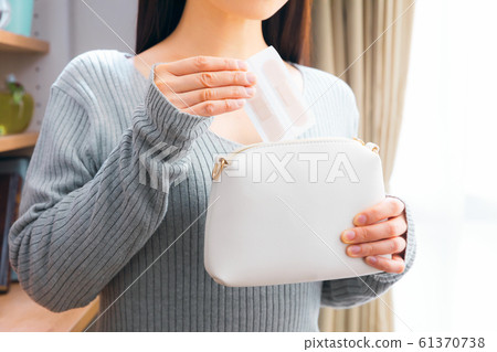 A woman putting a plaster on the porch 61370738