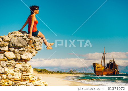 Tourist woman on beach enjoying vacation 61371072