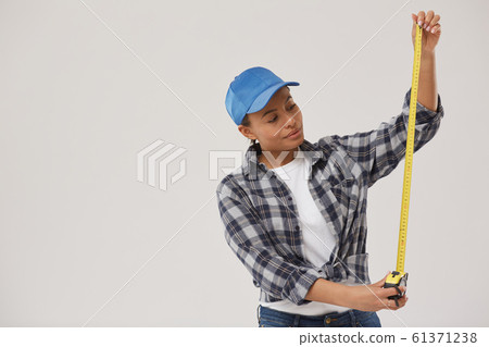 Female Worker Holding Measuring Tape on White 61371238