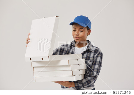 Mixed-Race Young Woman Delivering Pizza Mixed-Race Young Woman Delivering Pizza 61371246