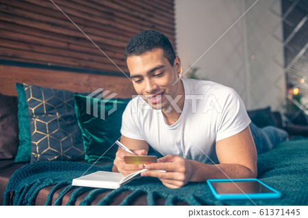 Guy with a business card in his hand. Guy with a business card in his hand. 61371445