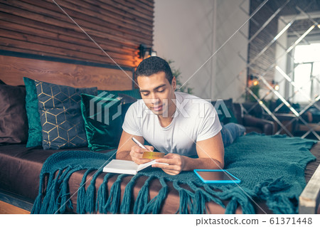 The guy writing with a pen in a notebook. The guy writing with a pen in a notebook. 61371448
