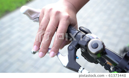 female hand making finger drum on bicycle steering female hand making finger drum on bicycle steering 61373448