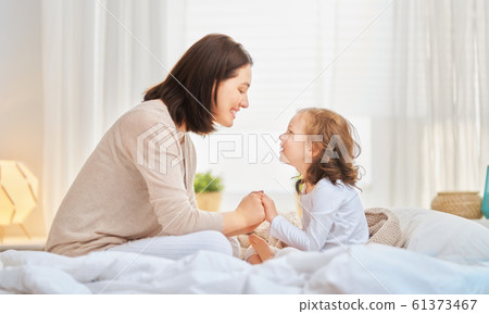 girl and her mother enjoy sunny morning 61373467