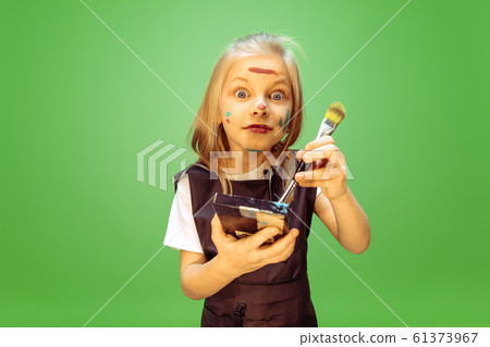Little girl dreaming about future profession of makeup artist 61373967