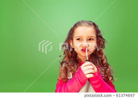 Little girl dreaming about future profession of makeup artist Little girl dreaming about future profession of makeup artist 61374697