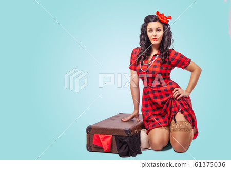 young woman sitting on the floor and putting 61375036