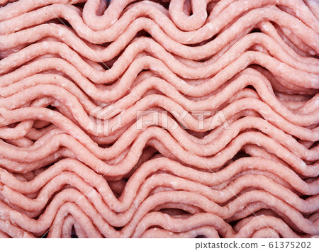 Minced turkey as background. The texture of minced turkey. Minced turkey as background. The texture of minced turkey. 61375202