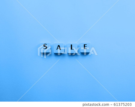 Sale word composed with plastic tiles on blue 61375203