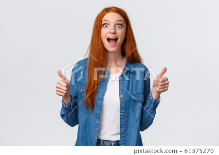 Speechless, excited and impressed redhead female cheering for friend scored goal, achieved success, great teamwork brought positive result, showing thumbs-up smiling and scream happy surprised Speechless, excited and impressed redhead female cheering for friend scored goal, achieved success, great teamwork brought positive result, showing thumbs-up smiling and scream happy surprised 61375270