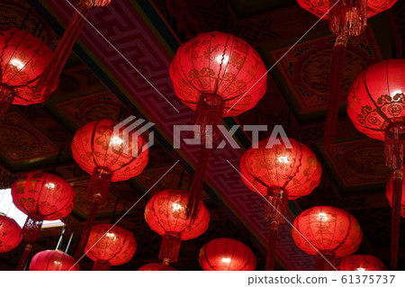 Many illuminated red Chinese lanterns with some Chinese characters on it Many illuminated red Chinese lanterns with some Chinese characters on it 61375737