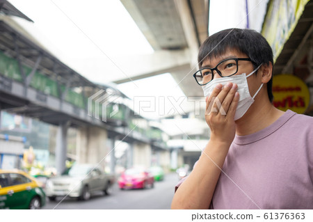 HandsomeMan wearing face mask protect filter HandsomeMan wearing face mask protect filter 61376363