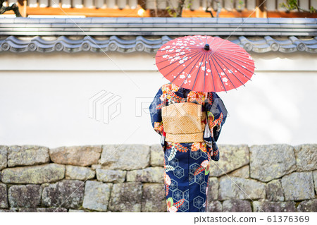 Geishas girl wearing Japanese kimono among red 61376369