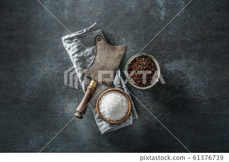 Old meat butcher on dark concrete board with Old meat butcher on dark concrete board with 61376739
