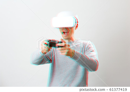 Man with virtual reality headset is playing game. Image with glitch effect. 61377419