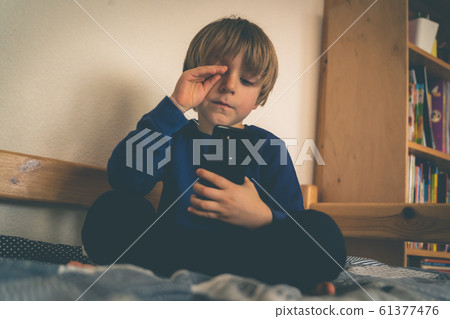 Cyber bullying concept - depressed boy with phone and negative comments 61377476