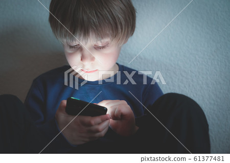 Cyber bullying concept - depressed boy with phone and negative comments 61377481