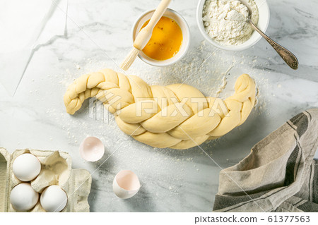 Making traditional jewish challah bread on marble background Making traditional jewish challah bread on marble background 61377563