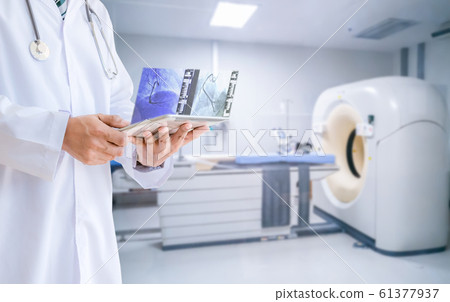 Medical doctor technology View MRI Magnetic Resonance Imaging X-ray results with a tablet Medical doctor technology View MRI Magnetic Resonance Imaging X-ray results with a tablet 61377937