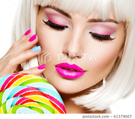 Face of a beautiful  girl with pink eye make-up 61379007