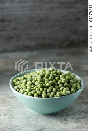 frozen green peas in a bowl frozen green peas in a bowl 61379211
