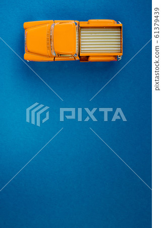 Yellow Retro car pickup on a blue-purple background. Top view with copy space. Flat lay Yellow Retro car pickup on a blue-purple background. Top view with copy space. Flat lay 61379439