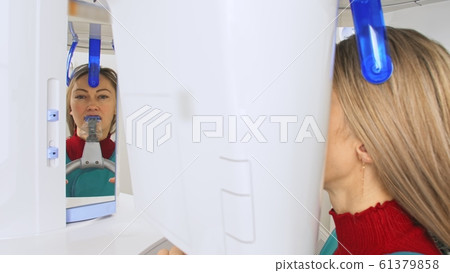 Doctor to take a image 3dx-ray machine 3d digital scanner tomography of teeth and jaw in modern laoratory dental clinic. Computer dental diagnostics. 61379858