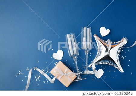 wineglasses and gift box on classic blue 61380242
