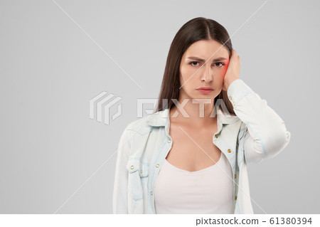 Woman showing earache. Woman showing earache. 61380394