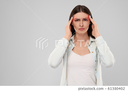 Woman showing headache. 61380402