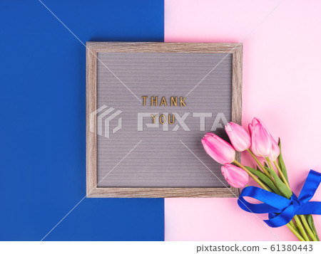 Thank you written on board with bunch of flowers Thank you written on board with bunch of flowers 61380443