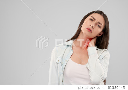 Woman touching neck because of pain. Woman touching neck because of pain. 61380445