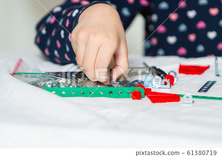 child plays with iron constructor child plays with iron constructor 61380719