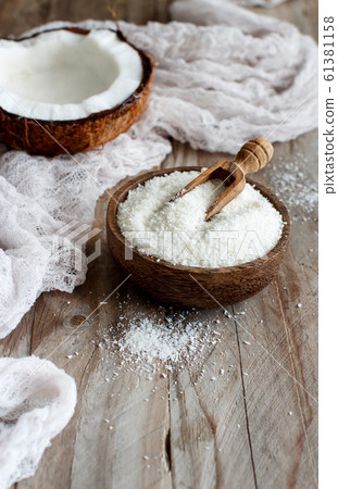 Coconut flour in a wooden bowl close up 61381158