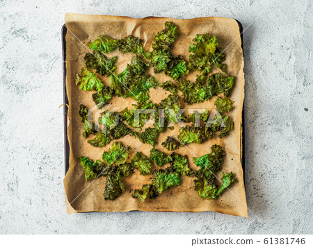Kale Chips with salt on oven-tray, top view Kale Chips with salt on oven-tray, top view 61381746