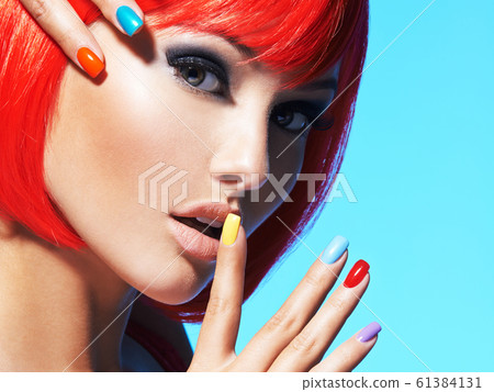 Portrait  of a model with red hairs and multicolor 61384131