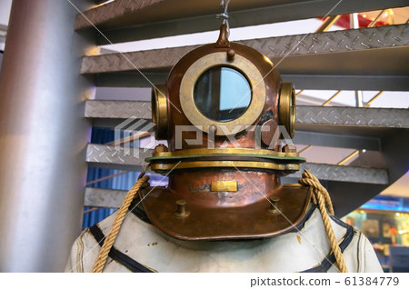 Close-up helmet Old vintage three-bolt deep-sea diving suit. Suit for deep sea diving of the last century. The history of the study of the underwater world 61384779
