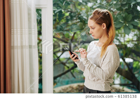 Young Woman Texting Messages Young Woman Texting Messages 61385138