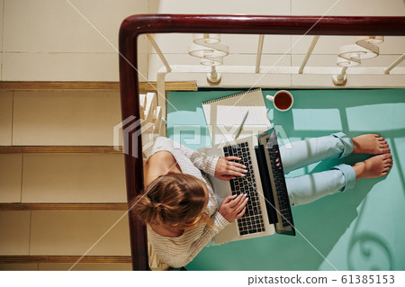 Woman With Laptop On Staircase 61385153