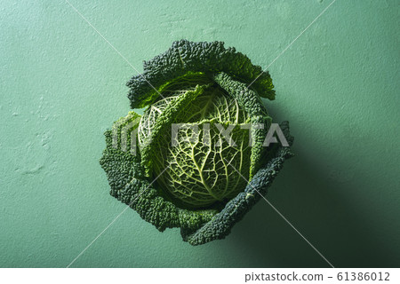 One cabbage on green background. Savoy cabbage. 61386012