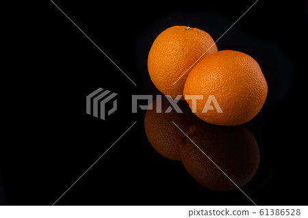 Couple of ripe oranges. 61386528