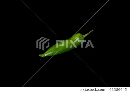 Green chili pepper on black background. Green chili pepper on black background. 61386645